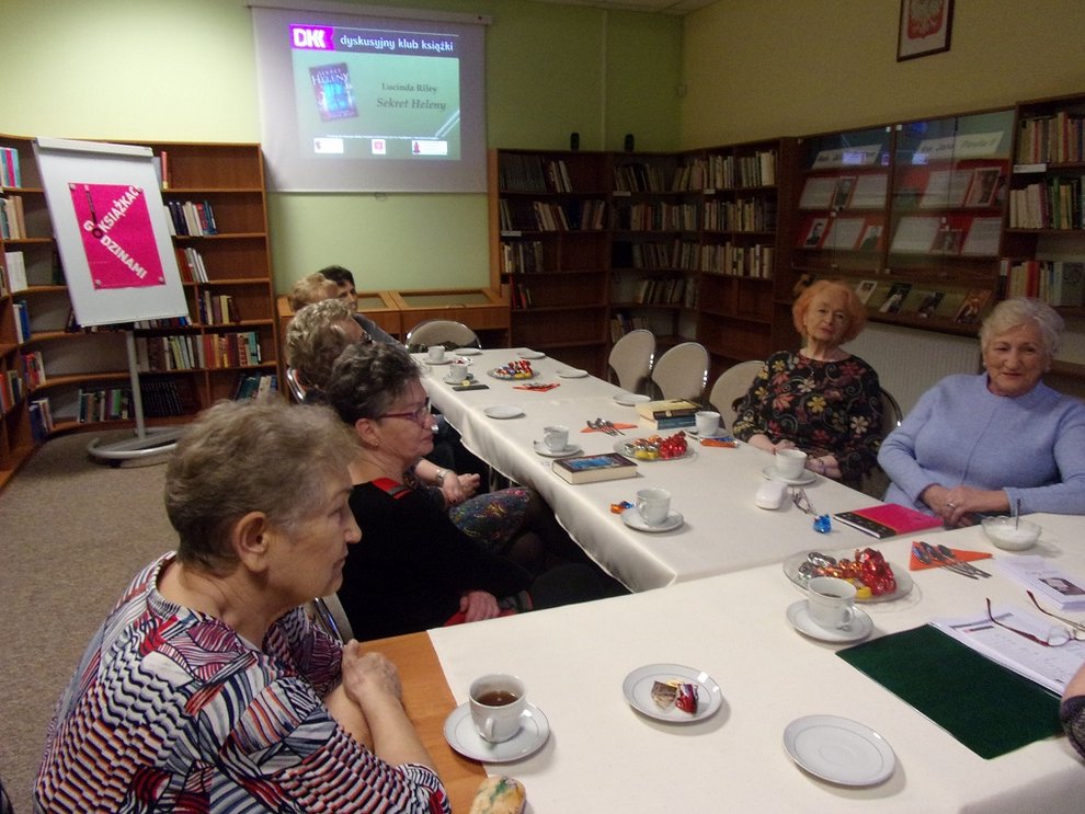 Ujęcie od szczytu stołów, widoczne jest 7 kobiet spoglądających w tą samąstronę