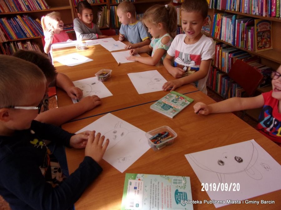 Zdjęcie dzieci pracujących na spotkaniu, dzieci rysują na kartkach króliczki.